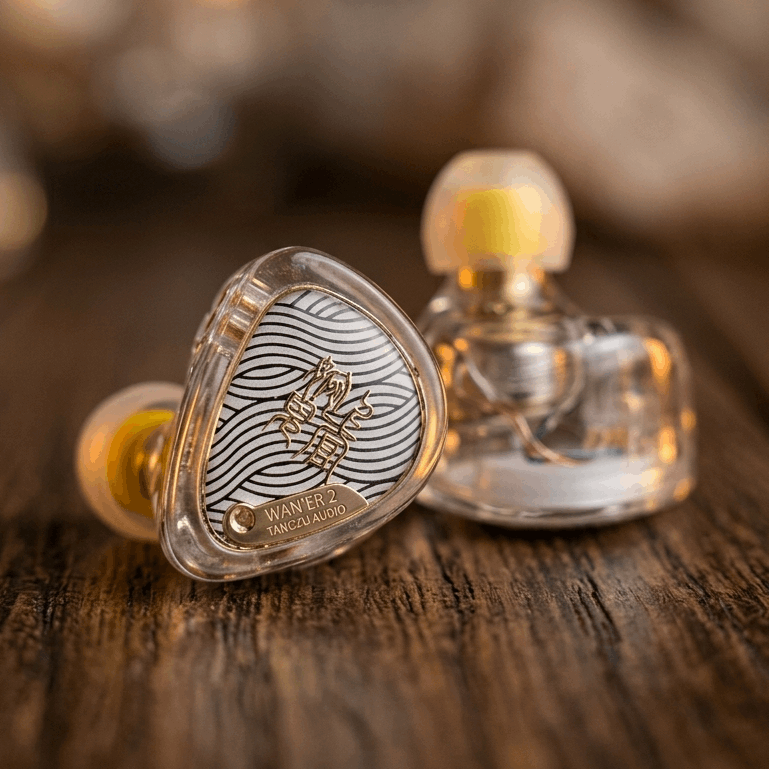 TangZu Waner 2 earphones with a clear housing and intricate design, showcasing a unique aesthetic on a wooden surface.