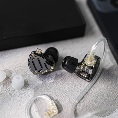 KZ ZS10 PRO 2 in-ear wired earphones with clear black housing and detachable transparent cable on a textured surface.